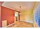 Bright living room with neutral tile flooring, shutters, and decorative pendant lighting at 579 Saint Andrews Rd, Winter Haven, FL 33884