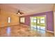 Spacious living room featuring neutral tile floors, a ceiling fan, and a large window at 579 Saint Andrews Rd, Winter Haven, FL 33884