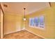 Bright living room with neutral tile flooring, shutters, and decorative pendant lighting at 579 Saint Andrews Rd, Winter Haven, FL 33884