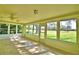 Bright sun room with tile flooring and many large windows to showcase outdoor view at 579 Saint Andrews Rd, Winter Haven, FL 33884