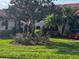 Exterior view of home surrounded by lush and colorful landscaping at 6001 Country Club Dr, Lake Wales, FL 33898