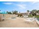 Relaxing hot tub area with lounge chairs, a privacy fence, and community buildings in the background at 6001 Country Club Dr, Lake Wales, FL 33898