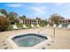 Community hot tub featuring lounge chairs, landscaping, and nearby community buildings at 6001 Country Club Dr, Lake Wales, FL 33898