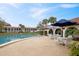 Community pool and patio area featuring ample seating and shade umbrellas at 6001 Country Club Dr, Lake Wales, FL 33898