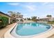 Large community pool with lounge chairs and umbrellas, set against a clear blue sky at 6001 Country Club Dr, Lake Wales, FL 33898