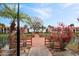 Scenic view of a waterfront deck with tropical landscaping and community buildings in the background at 6001 Country Club Dr, Lake Wales, FL 33898