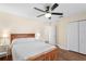 Cozy bedroom featuring a wooden bed frame, ceiling fan, and ample closet space at 627 Watercrest Dr, Haines City, FL 33844
