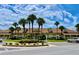 Attractive community center with well-maintained landscaping, complemented by mature palm trees at 627 Watercrest Dr, Haines City, FL 33844