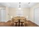 Cozy dining room featuring a wooden table, chairs, and elegant lighting fixture at 627 Watercrest Dr, Haines City, FL 33844