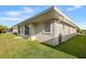 Home exterior showcasing well-maintained lawn and stucco siding with a side patio at 627 Watercrest Dr, Haines City, FL 33844