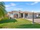 Charming home features lush lawn, well-maintained landscaping, and a brick driveway leading to a two-car garage at 627 Watercrest Dr, Haines City, FL 33844