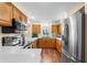Modern kitchen featuring stainless steel appliances, wooden cabinets, and ample counter space at 627 Watercrest Dr, Haines City, FL 33844