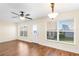 Inviting living room with two windows allowing ample light and a ceiling fan at 627 Watercrest Dr, Haines City, FL 33844