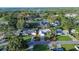 Aerial view of a home featuring a well-maintained yard, pool, and neighborhood at 672 Wakulla Dr, Winter Haven, FL 33884