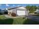 Side view of a home featuring an attached garage and well-kept lawn at 672 Wakulla Dr, Winter Haven, FL 33884