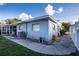 Exterior view of a home showing the walkway around to the screened porch at 672 Wakulla Dr, Winter Haven, FL 33884