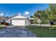 Charming single-story home with a two-car garage and mature landscaping at 672 Wakulla Dr, Winter Haven, FL 33884