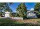 A view of the side of the house with a garage and landscaping at 672 Wakulla Dr, Winter Haven, FL 33884