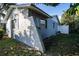 Side exterior view of the home with a textured wall and garden at 672 Wakulla Dr, Winter Haven, FL 33884