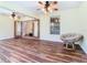 Living room with wood floors, ceiling fans, and doors leading to another room at 960 Old Cutler Rd, Lake Wales, FL 33898