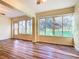 Bright living room with wood floors and large windows overlooking a green area at 960 Old Cutler Rd, Lake Wales, FL 33898