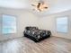 Main bedroom with luxury vinyl plank flooring, ceiling fan and large windows at 960 Old Cutler Rd, Lake Wales, FL 33898