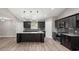 Contemporary kitchen featuring pendant lighting, dark cabinets, and granite countertops at 221 Avenue P Nw, Winter Haven, FL 33881