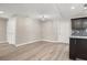 Neutral living room area with updated light fixture, new flooring, and lots of natural light at 221 Avenue P Nw, Winter Haven, FL 33881