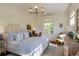 Sunlit bedroom with a striped headboard, desk, and soft color palette at 2300 Scenic N Hwy # 51, Lake Wales, FL 33898