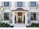 Elegant home featuring a covered entry, light blue shutters, and a refined front garden at 2300 Scenic N Hwy # 51, Lake Wales, FL 33898