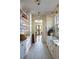 A bright kitchen with white cabinets, marble countertops, and herringbone-patterned floors at 2300 Scenic N Hwy # 51, Lake Wales, FL 33898