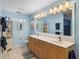 Bright bathroom with a double vanity, ample lighting, and coastal-themed decor at 4189 Limerick Dr, Lake Wales, FL 33859