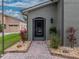 Charming home entrance featuring a well-manicured lawn and beautiful landscaping at 4189 Limerick Dr, Lake Wales, FL 33859