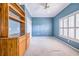 Light blue bedroom with built-in shelves and window with shutters at 11 Lefe Ct, Haines City, FL 33844