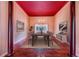 Formal dining room with hardwood floors, red ceiling, and large windows at 11 Lefe Ct, Haines City, FL 33844