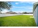 Expansive backyard featuring a white fence, lush lawn, and ample space for outdoor activities at 2821 Sheldon St, Lakeland, FL 33813