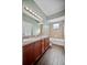 Bathroom featuring double vanity, tub-shower combo, and wooden cabinets at 2821 Sheldon St, Lakeland, FL 33813