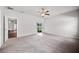 Bright bedroom with a ceiling fan, carpet flooring, and sliding glass doors to the backyard at 2821 Sheldon St, Lakeland, FL 33813