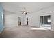 Bright bedroom with a ceiling fan, carpet flooring, and access to an ensuite bathroom at 2821 Sheldon St, Lakeland, FL 33813