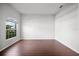 Minimalist bedroom with dark wood floors, large windows, and a neutral color palette at 2821 Sheldon St, Lakeland, FL 33813