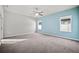 Large bedroom with a ceiling fan, carpet flooring, and bright, light-blue accent wall at 2821 Sheldon St, Lakeland, FL 33813