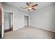 Bedroom with ceiling fan, carpet, and view to closet and hall at 2821 Sheldon St, Lakeland, FL 33813