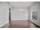 Spacious dining room featuring dark wood floors, a chandelier, and window with blind at 2821 Sheldon St, Lakeland, FL 33813