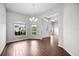 Bright dining room featuring hardwood floors, two large windows, and an elegant chandelier at 2821 Sheldon St, Lakeland, FL 33813