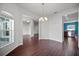 Dining room featuring dark wood floors, chandelier, and views into adjacent living spaces at 2821 Sheldon St, Lakeland, FL 33813