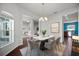 Modern dining room with a marble table, chandelier, and stylish chairs, with views into living spaces at 2821 Sheldon St, Lakeland, FL 33813