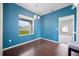 Bright dining room with modern lighting, wood floors and a view to the landscaped backyard at 2821 Sheldon St, Lakeland, FL 33813