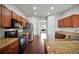 Kitchen with wood cabinets, granite countertops, stainless steel appliances, and hardwood floors at 2821 Sheldon St, Lakeland, FL 33813