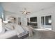 Spacious main bedroom featuring a ceiling fan, tv, sliding glass doors, and an ensuite bathroom at 2821 Sheldon St, Lakeland, FL 33813