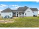 Backyard with a covered vehicle, well-manicured lawn, and back porch of the light-blue home at 4071 Albritton Rd, St Cloud, FL 34772